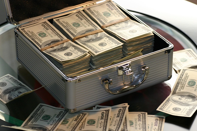 Do Startups Need Venture Capital? - A silver suitcase showcasing stacks of US dollar bills.