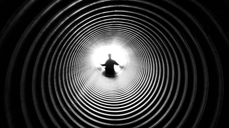 Thoughts From A Walk - A tunnel leading to a person on the other end (black and white image).