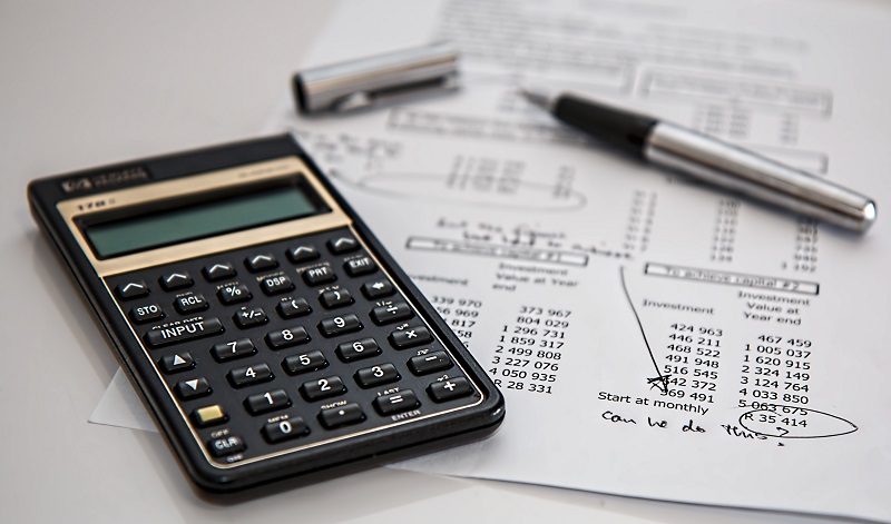 Do Startups Need Venture Capital? - A caculator beside a sheet of paper with an uncapped fountain pen on top. The piece of paper seems to be an accounting statement.