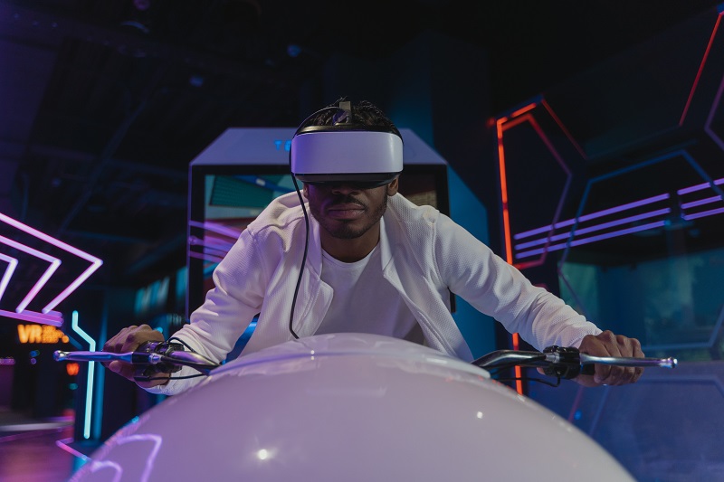 A man with VR Visor on a futurstic bike simulator