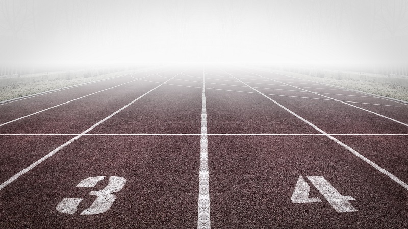 Secrets To Success  - An image showing the starting line of a running race track. The start numbers seen are 3 and 4.