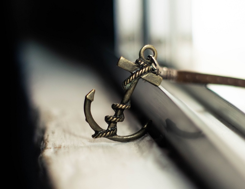 A small model the size of a key chain anchor coming into a home through a window