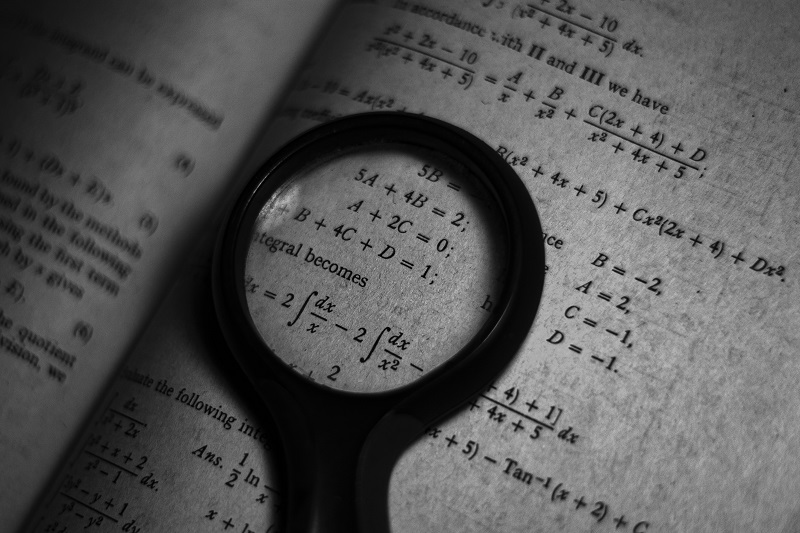 5 Reasons Not to Hate Mathematics: Mathematical equations looked through a magnifying glass