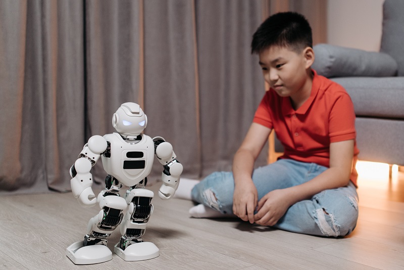 A child playing with the mean looking artificial intelligence robot from earlier