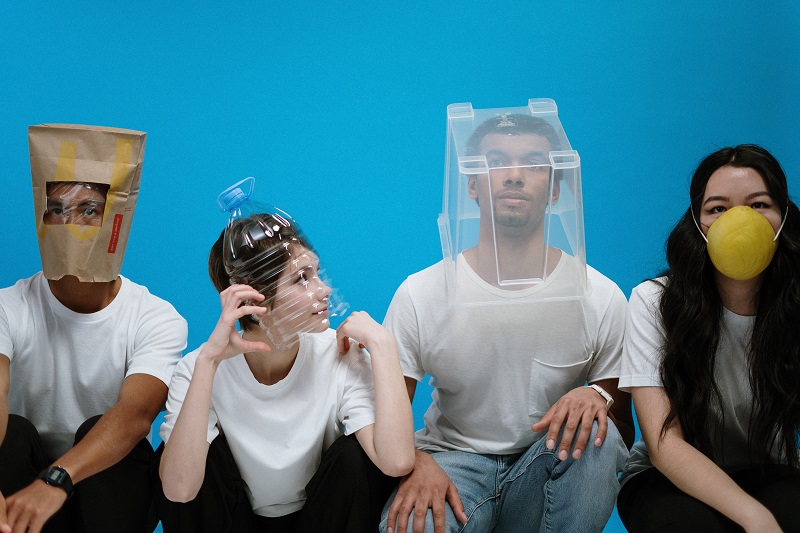 4 people uniquely covering their faces / mouths in fear of bad breath as an illustration of lack of radical honesty