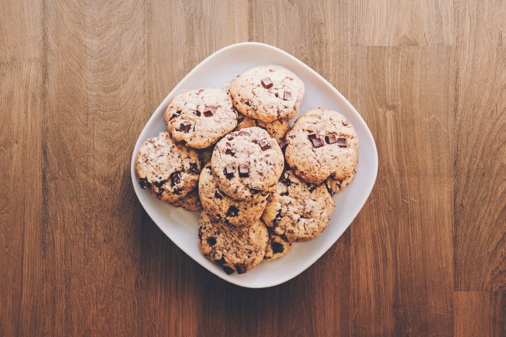 A bowl of delicious looking cookies on a brown table