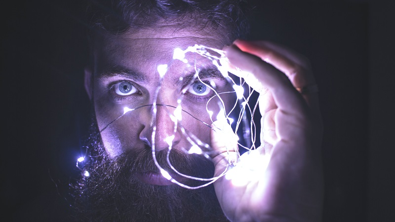 Feature Image of a bearded man with LEDs around to illustrate the concern of dying brain cells