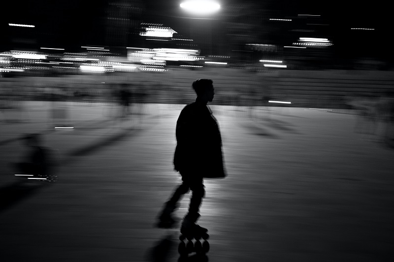 An blurry black and white image of a skater at night - to illustrate why you love negativity