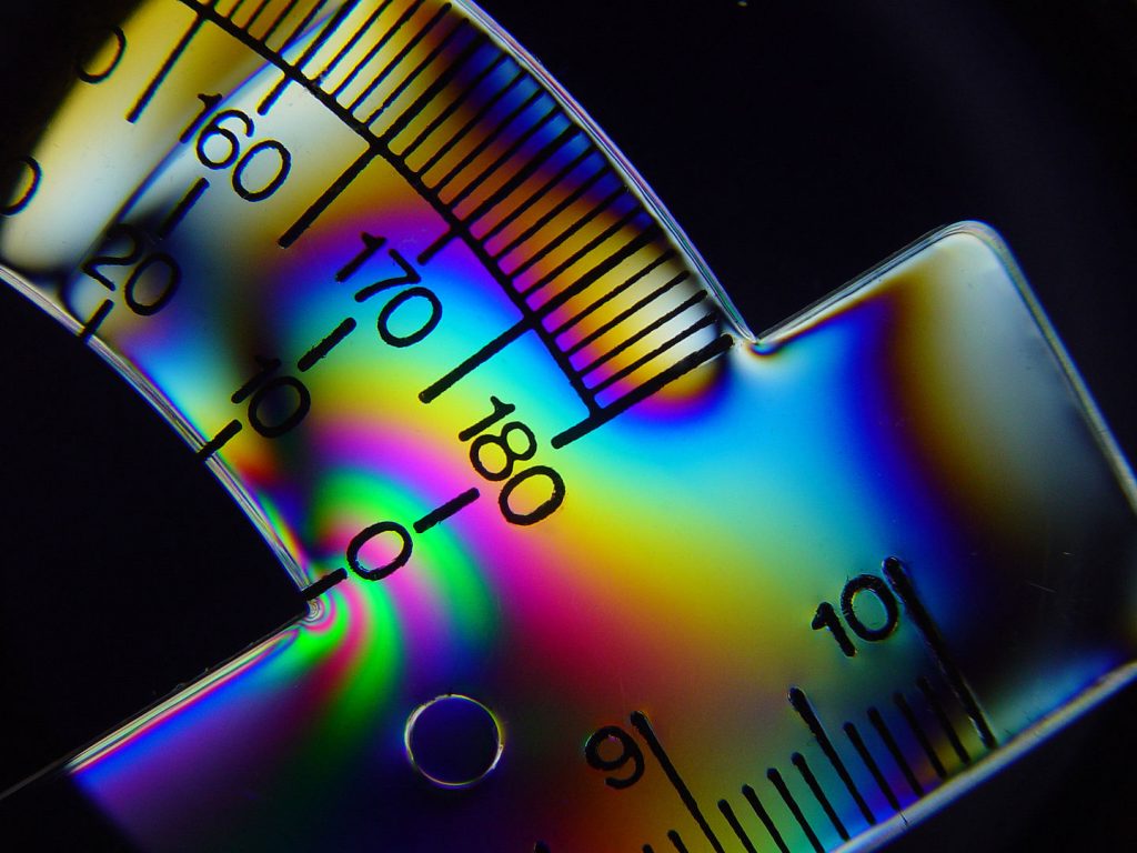 Residual stresses in a plastic protractor revealed by polarised light, as an analogy to why plastig bags tear easily when already cut