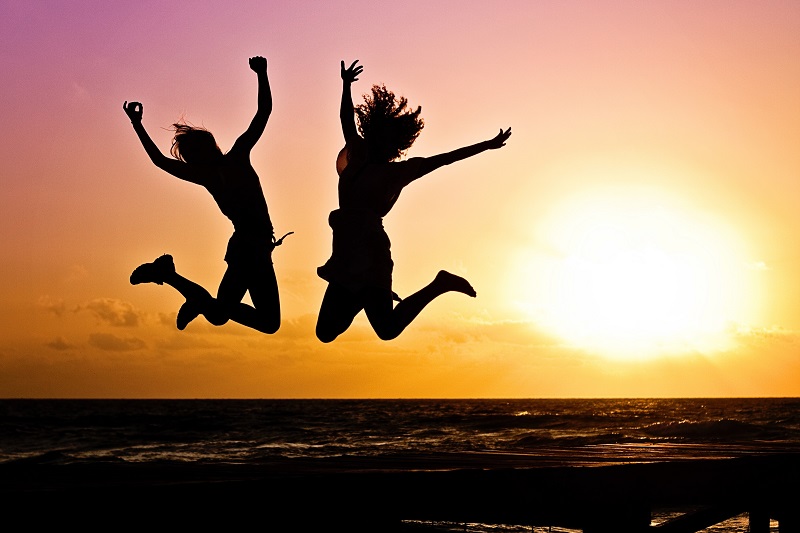 Two people jumping up in the air celebrating winning at something - to illustrate how to learn faster and more efficiently